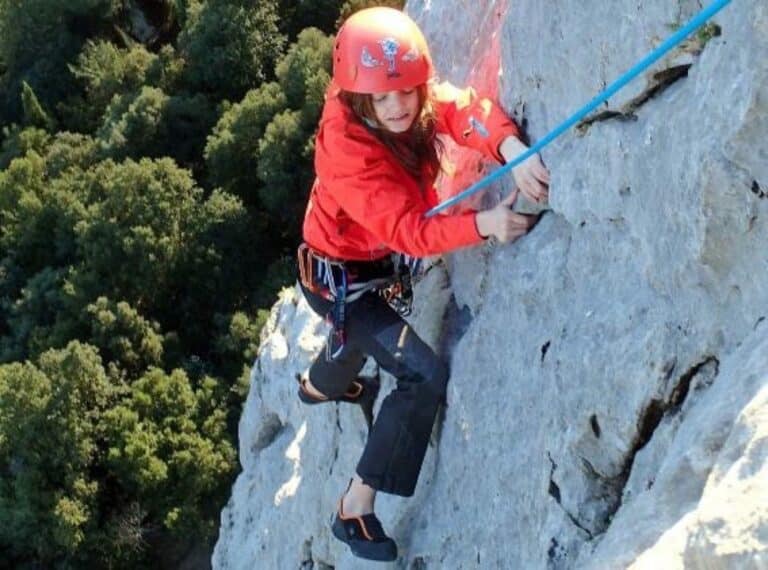 Une jeune fille en leçon d'escalade sur les falaises du Thaurac