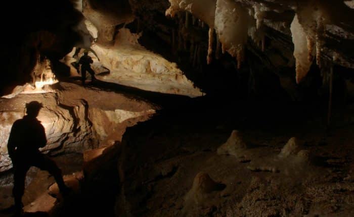 Un homme dans une des cavités de la grotte de genevaux